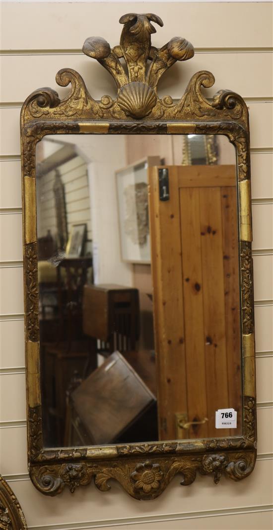 A George I design parcel gilt wall mirror, with shell and acanthus plume pediment H.90cm